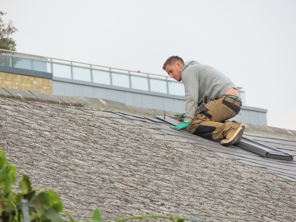 Roofer working on a section of an existing roof